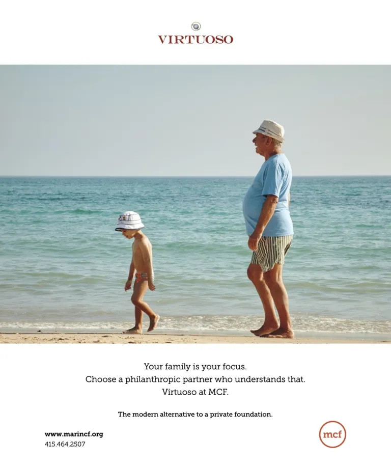 An adult and child walk on the beach; an ad for VIRTUOSO philanthropy.