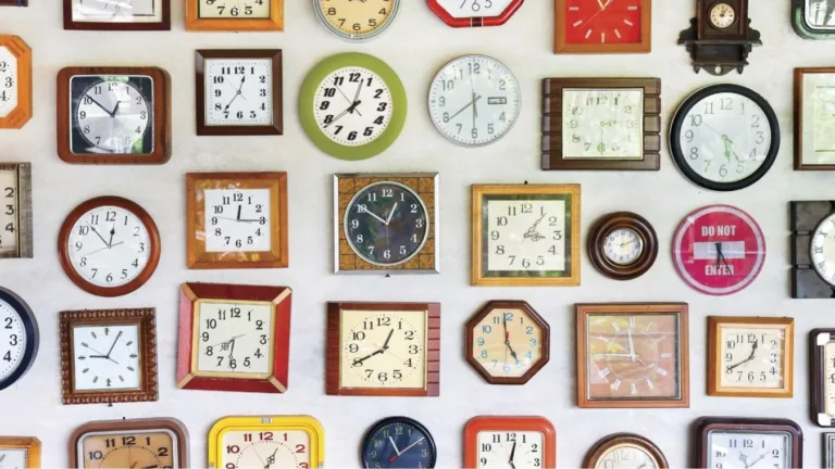A collage of various clocks on a wall with a Virtuoso advertisement at the bottom.