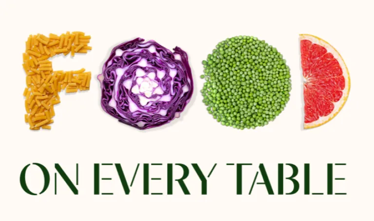 Image of the word Food spelled out using pasta, red cabbage, peas and grapefruit