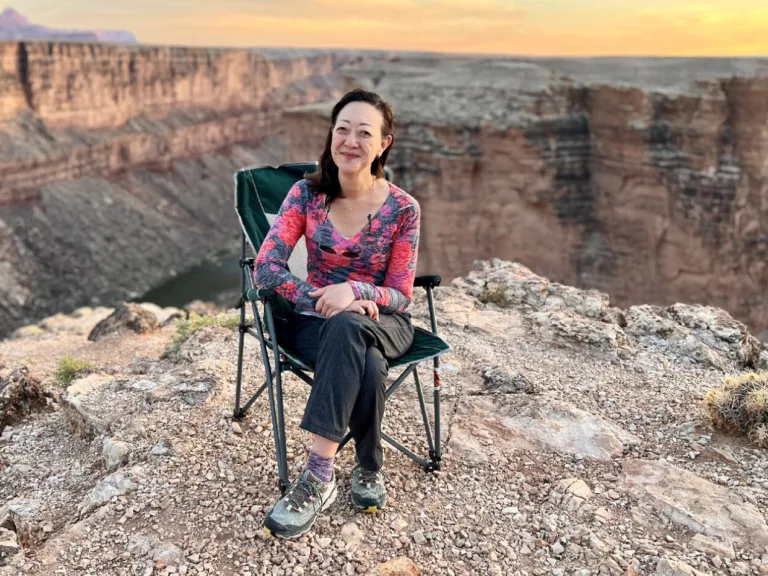 Rhea Suh sitting in a lawn chair at the Grand Canyon