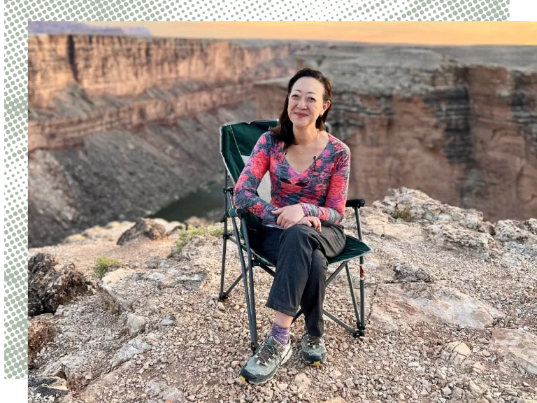 Rhea Suh sitting in a lawn chair at the Grand Canyon