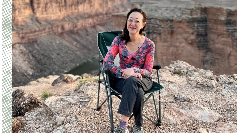 Rhea Suh sitting in a lawn chair at the Grand Canyon