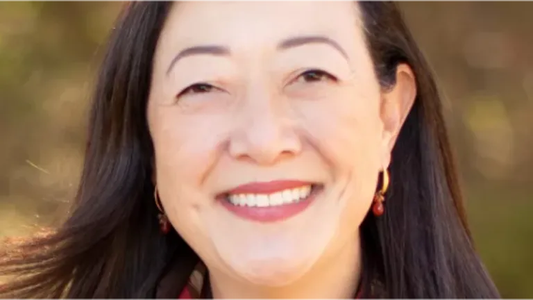 Rhea Suh, the president and CEO of MCF faces the camera smiling for her portrait