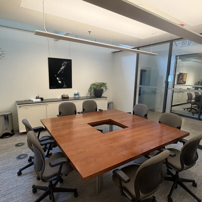 Image of MCF Oak room. Image contains square desk with chairs around it