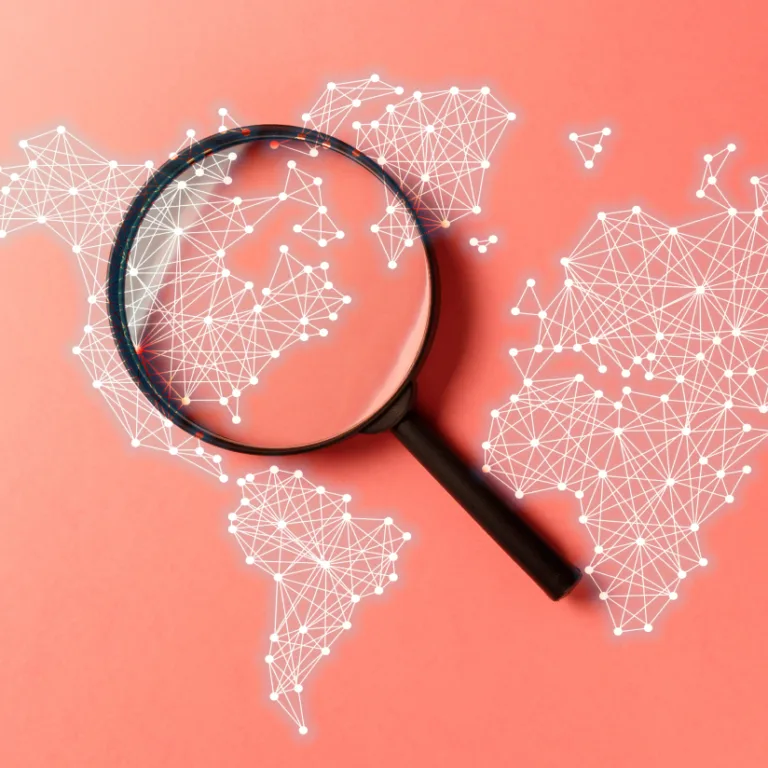 Magnifying glass over a digital world map network on a red background.