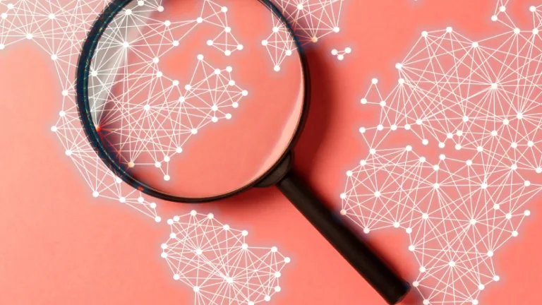 Magnifying glass over a digital world map network on a red background.
