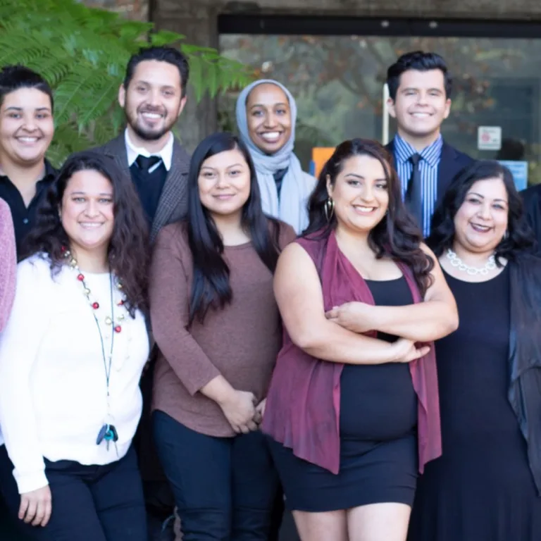 A group of people posing together for a photo outdoors.