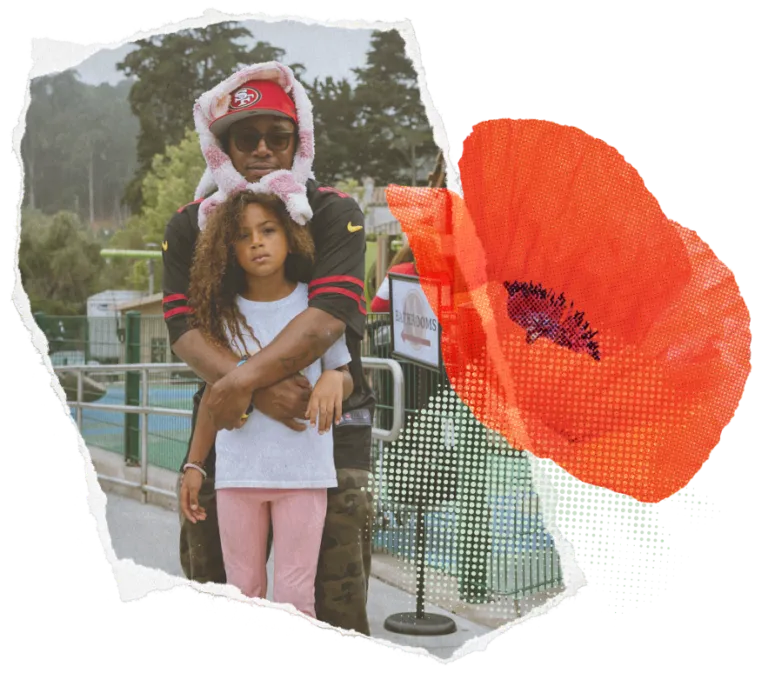 Embracing dad and daughter with a digitally overlaid red flower on the right side.