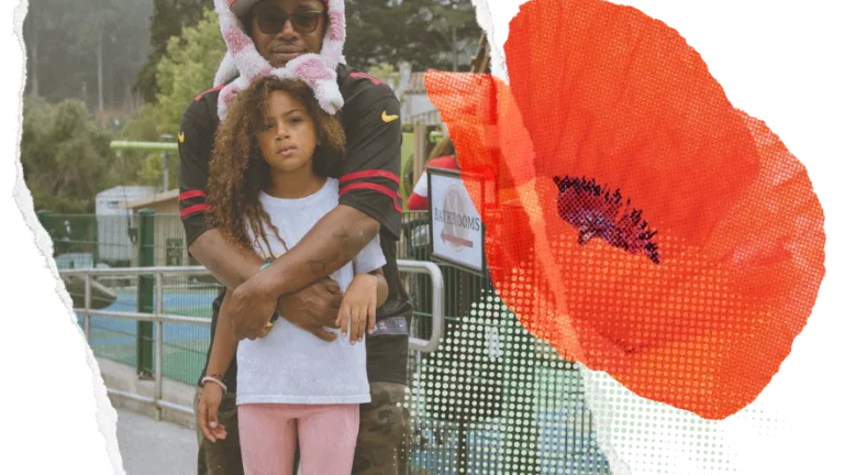 Embracing dad and daughter with a digitally overlaid red flower on the right side.