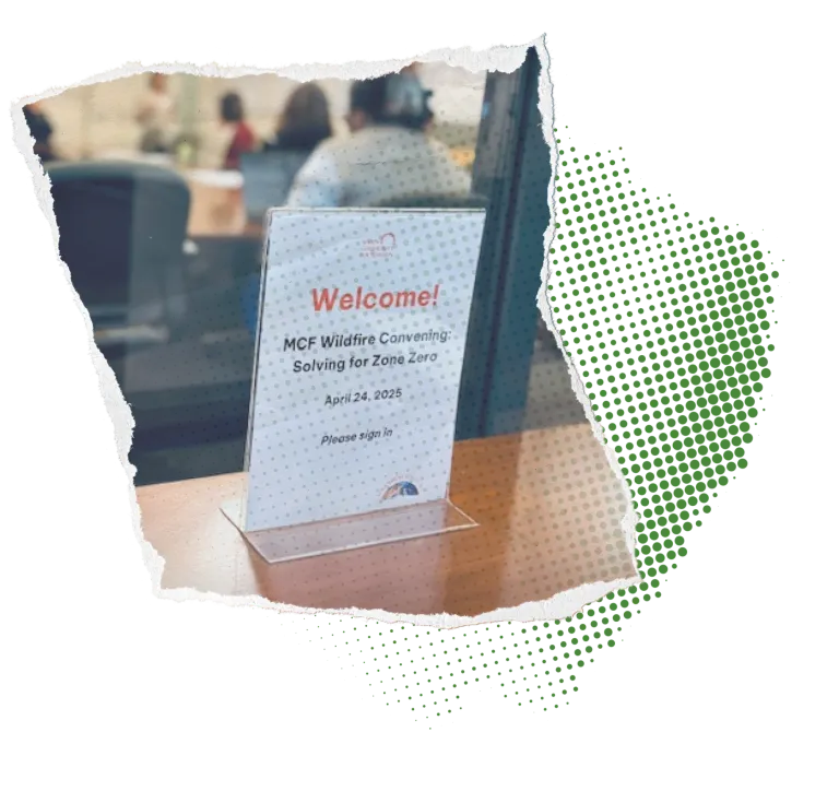 MCF wildfire convening Sign outside a meeting room of people, welcoming attendees to a wildfire convening; green half tone background
