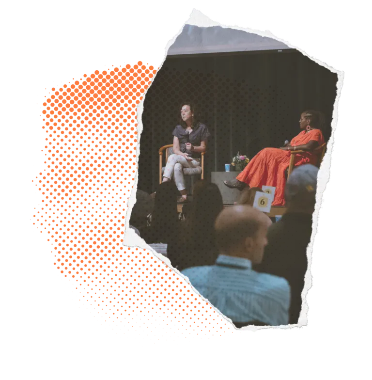 Two people on stage during a discussion in front of an audience, with a torn paper effect on the left.