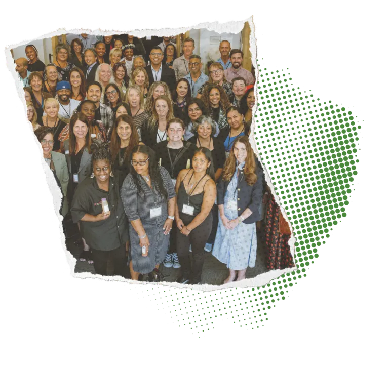 Group of diverse people smiling for a photo at a gathering, with a torn paper edge effect.