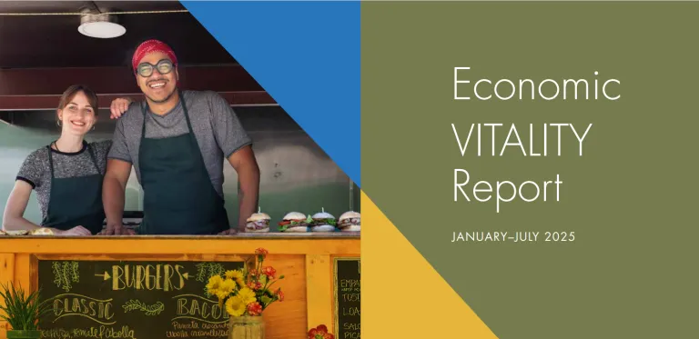 Image of the front cover of a report, featuring two smiling small business owners in a store