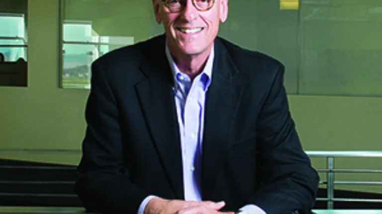Tom Peters standing at the upstairs rail in the MCF Office