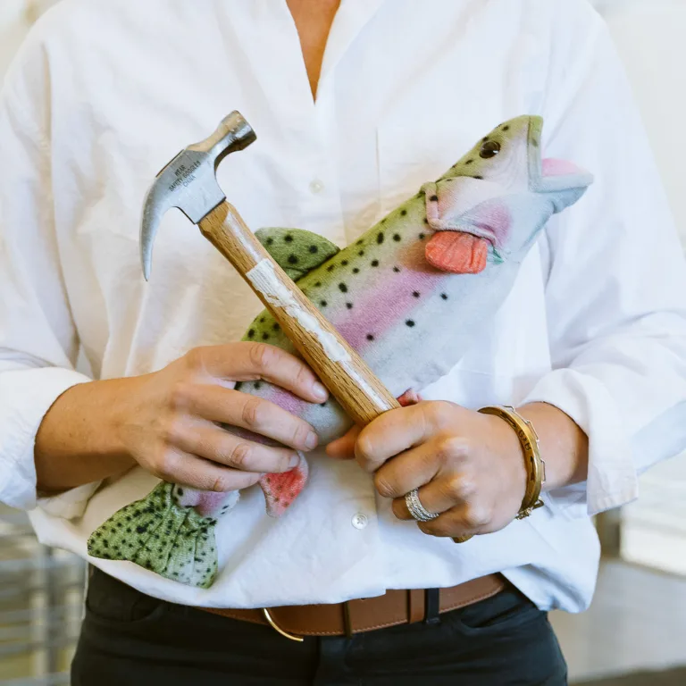 Lindsay Cope Bouchelle holding fish and hammer