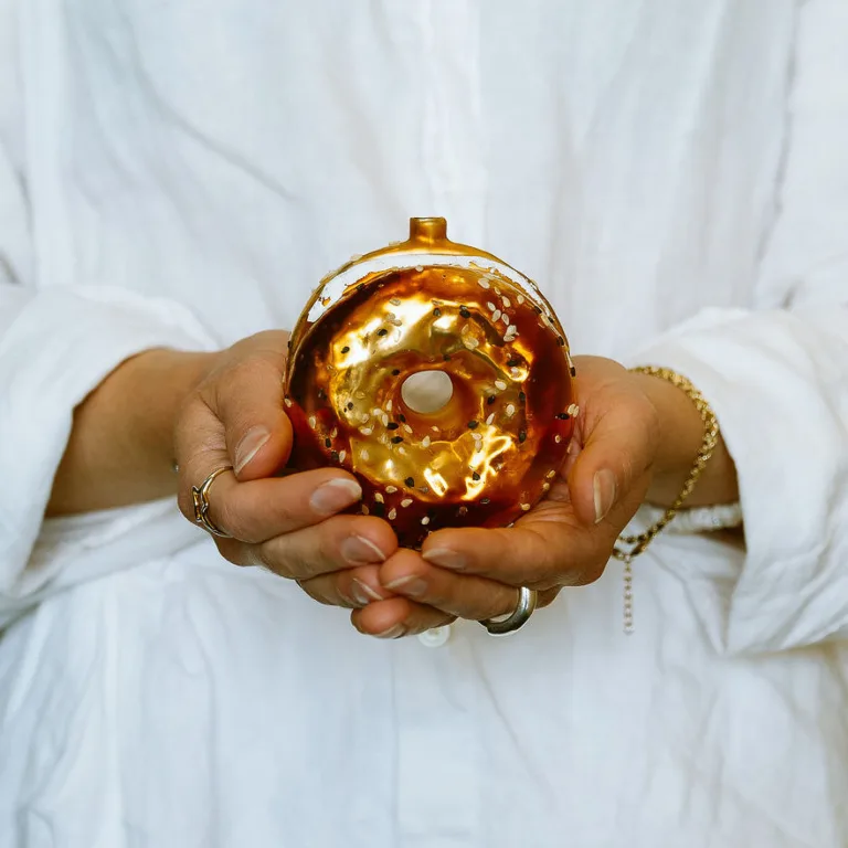 Chloe Karafelis holding golden bagel