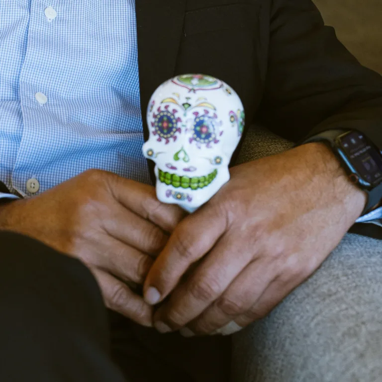 Saul Macias holding painted skull