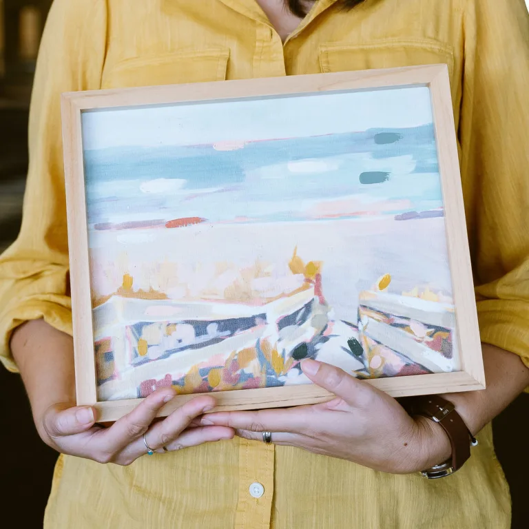 Julie Nakao holding a watercolor painting