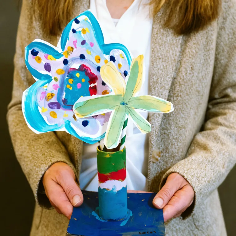 Lauren McClelland holding flower art project