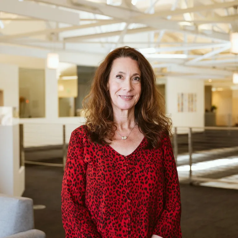 Headshot of Bonnie Grossman wearing a red v-neck blouse