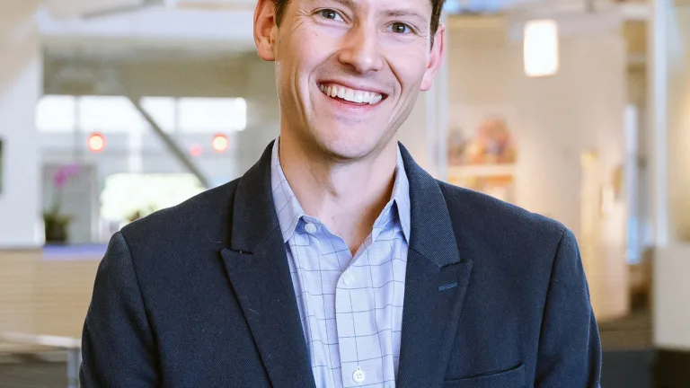 Headshot of Jason Blau wearing suit