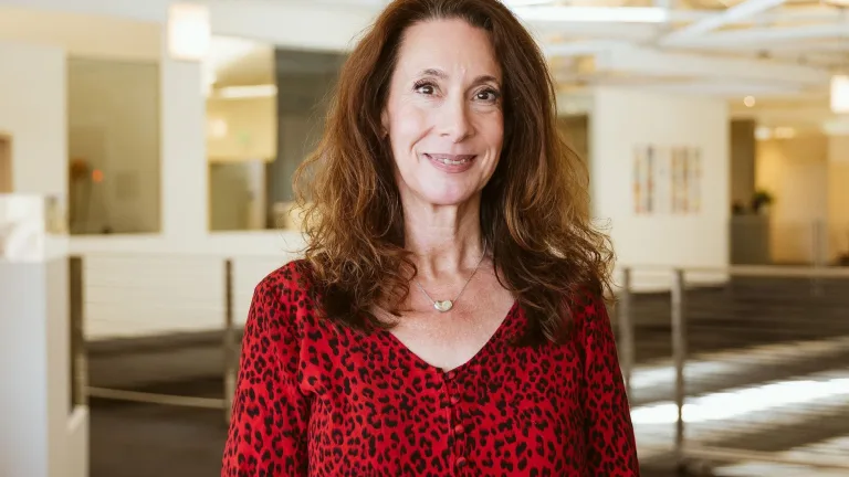 Headshot of Bonnie Grossman wearing a red v-neck blouse